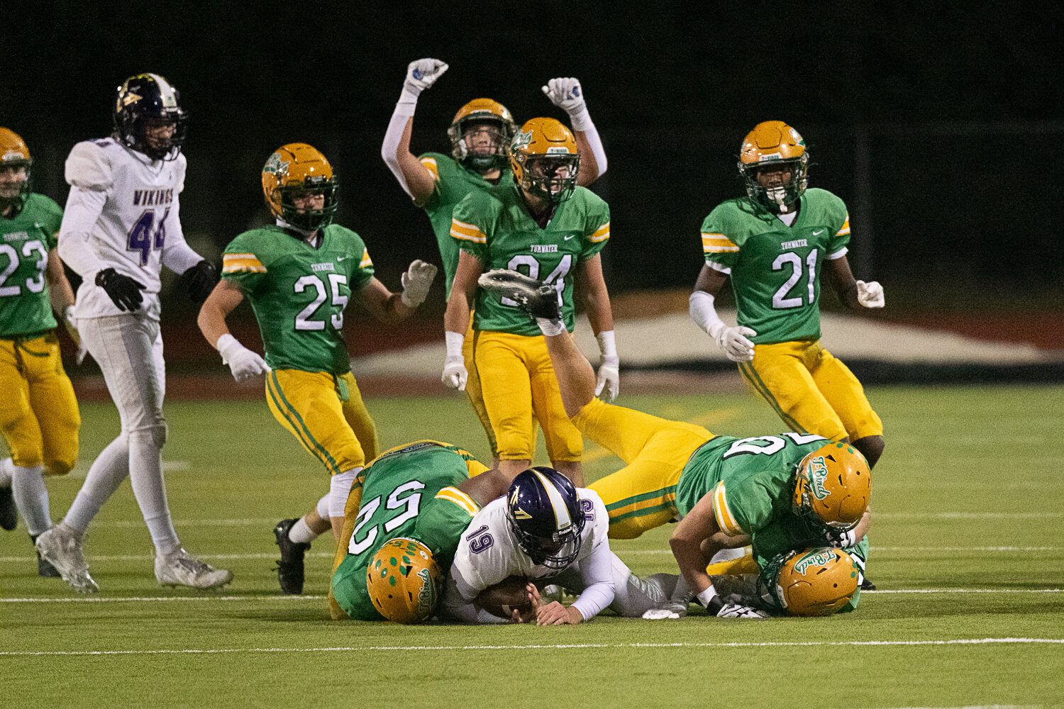 Tumwater defenders stop the North Kitsap ballcarrier well short on fourth down after a bad snap on a field goal attempt during the second half of the Thunderbirds' 19-17 win over North Kitsap in the 2A state semifinals on Nov. 25.