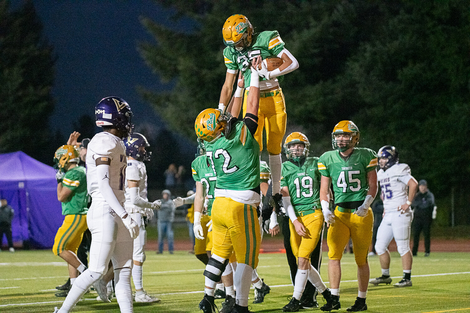 Brady Larson lifts up Kooper Clark after Clark's touchdown to start the scoring in Tumwater's 19-17 win over North Kitsap in the 2A state semifinals on Nov. 25.