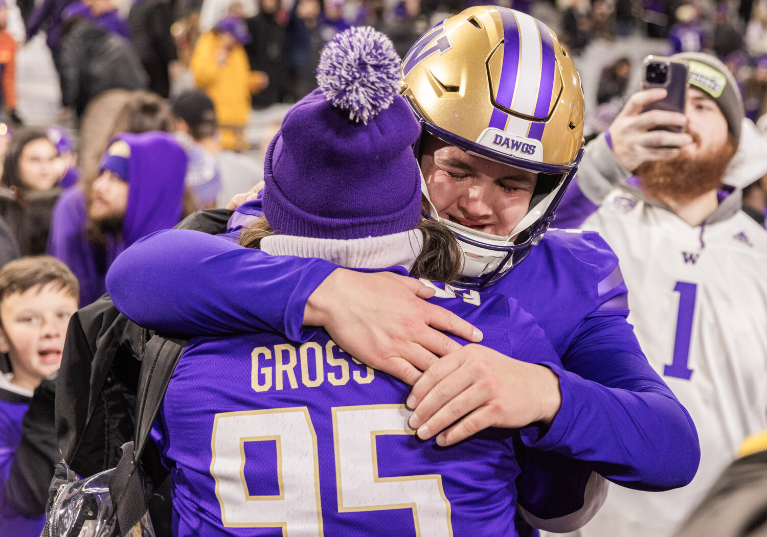 Huskies kicker Grady Gross receives an embrace after scoring the winning field goal during the Boeing Apple Cup Series football game in Seattle against the Washington State University Cougars on Saturday, Nov. 25.