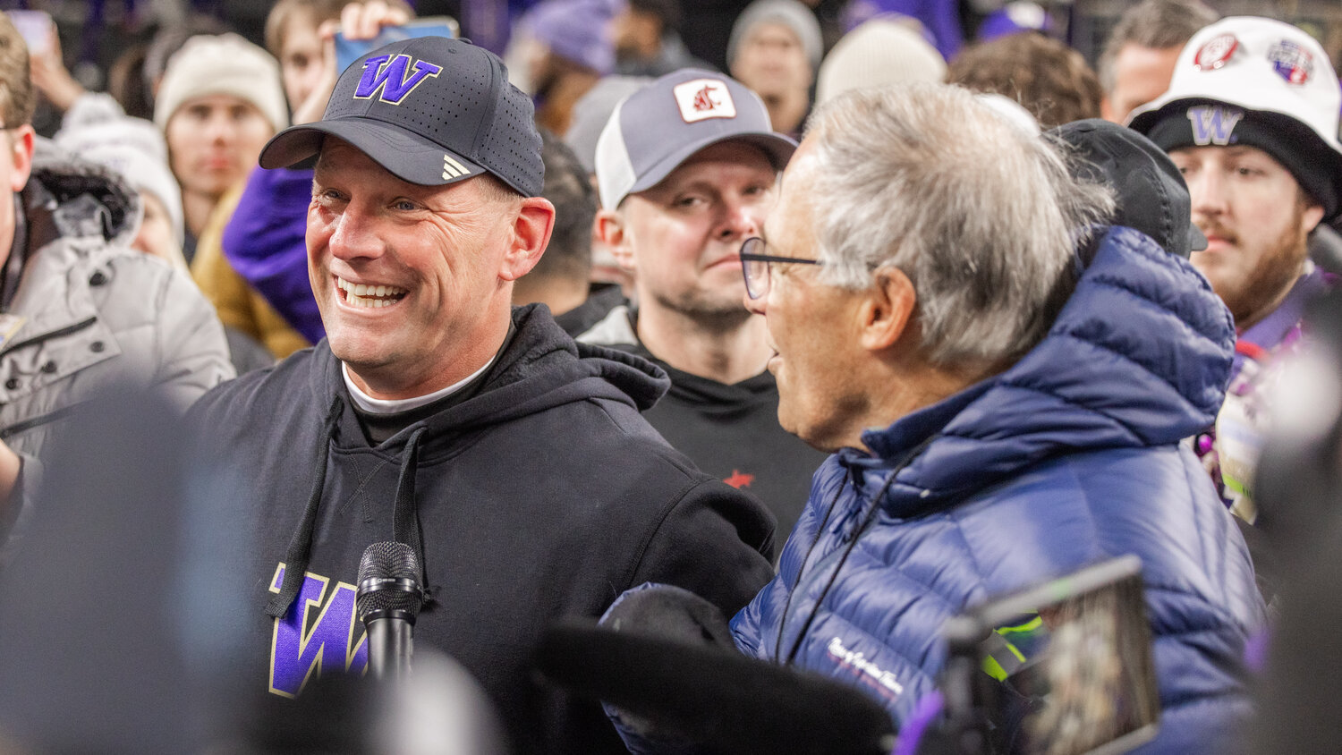 Huskies Head Coach Kalen DeBoer smiles after receiving the Boeing Apple Cup trophy from Governor Jay Inslee in Seattle after defeating the Washington State University Cougars on Saturday, Nov. 25.
