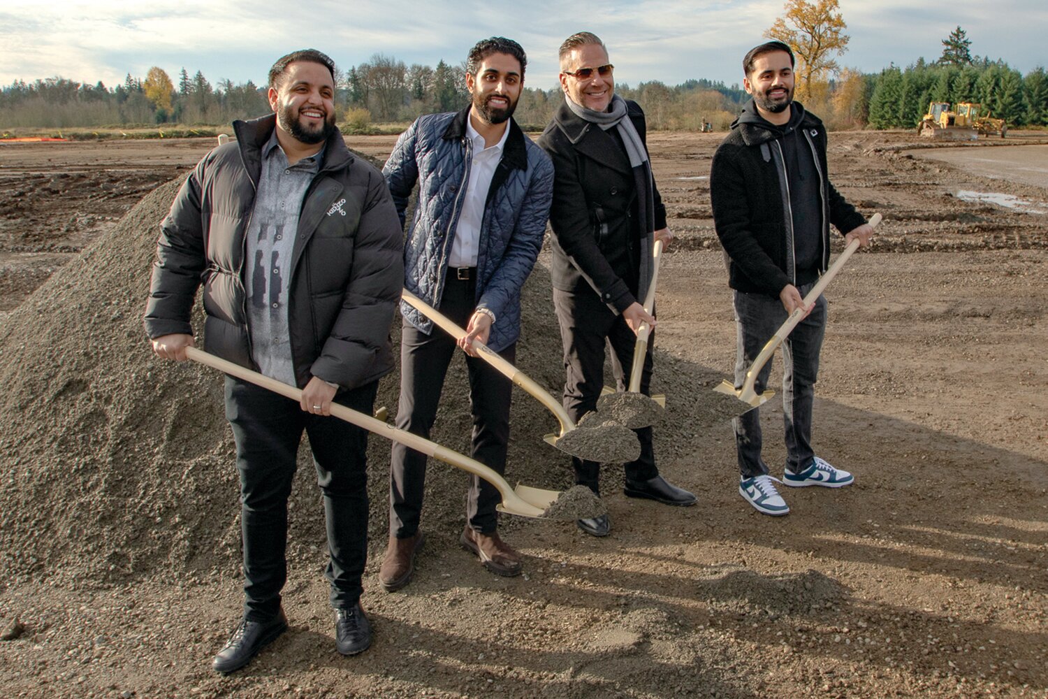 From the left, TA Napavine co-owner Damanjit Singh, TA Napavine co-owner Gurinderjit Sidhu, TA representative Ted Blevins and TA Napavine co-owner Manpreet Singh pose for a photo during a groundbreaking ceremony on Tuesday, Nov. 21, celebrating the construction of the new TA truck stop in Napavine.