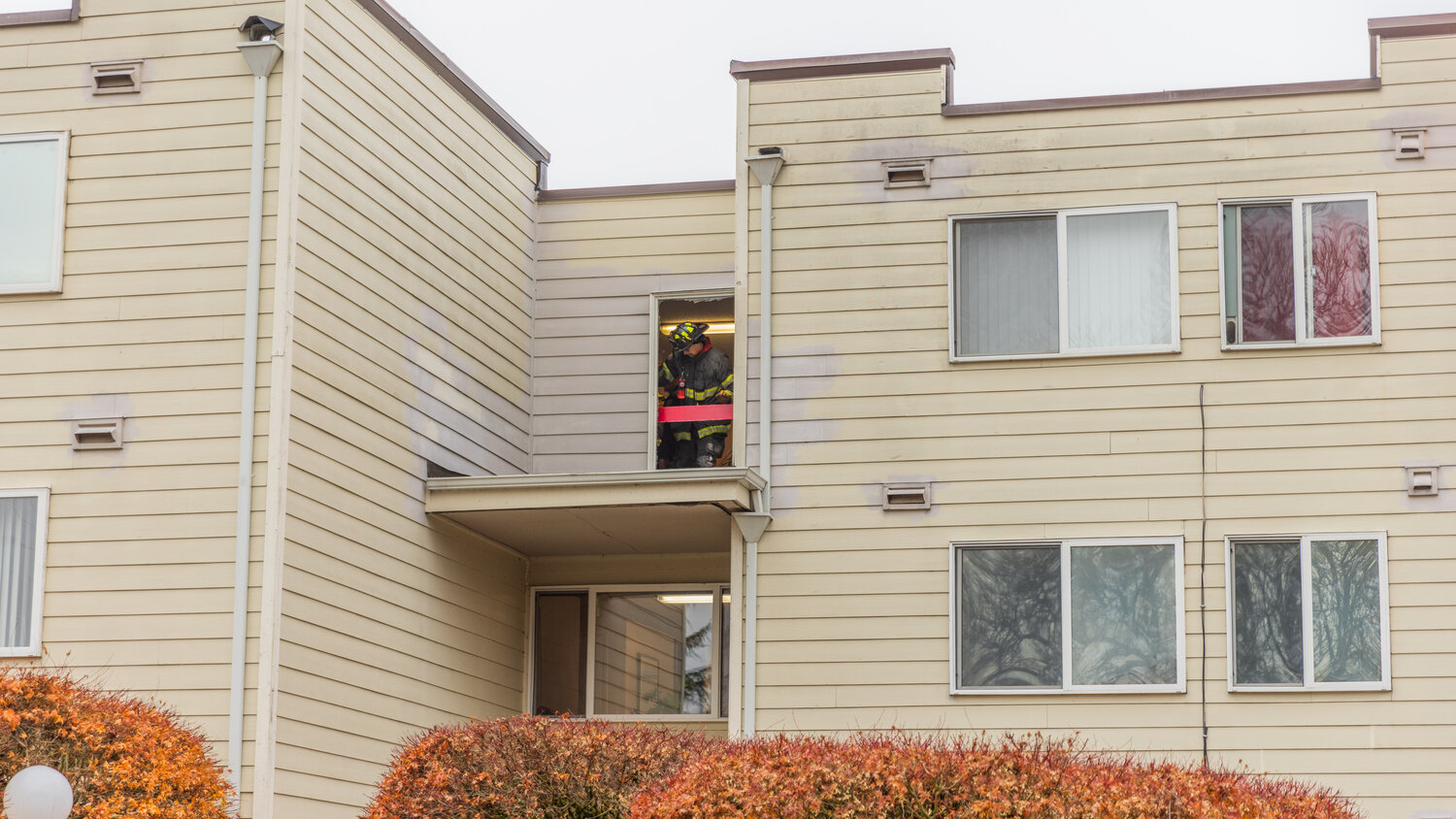 A firefighter inspects a window following a fire at the Centralia Manor Apartments Wednesday, Nov. 29.