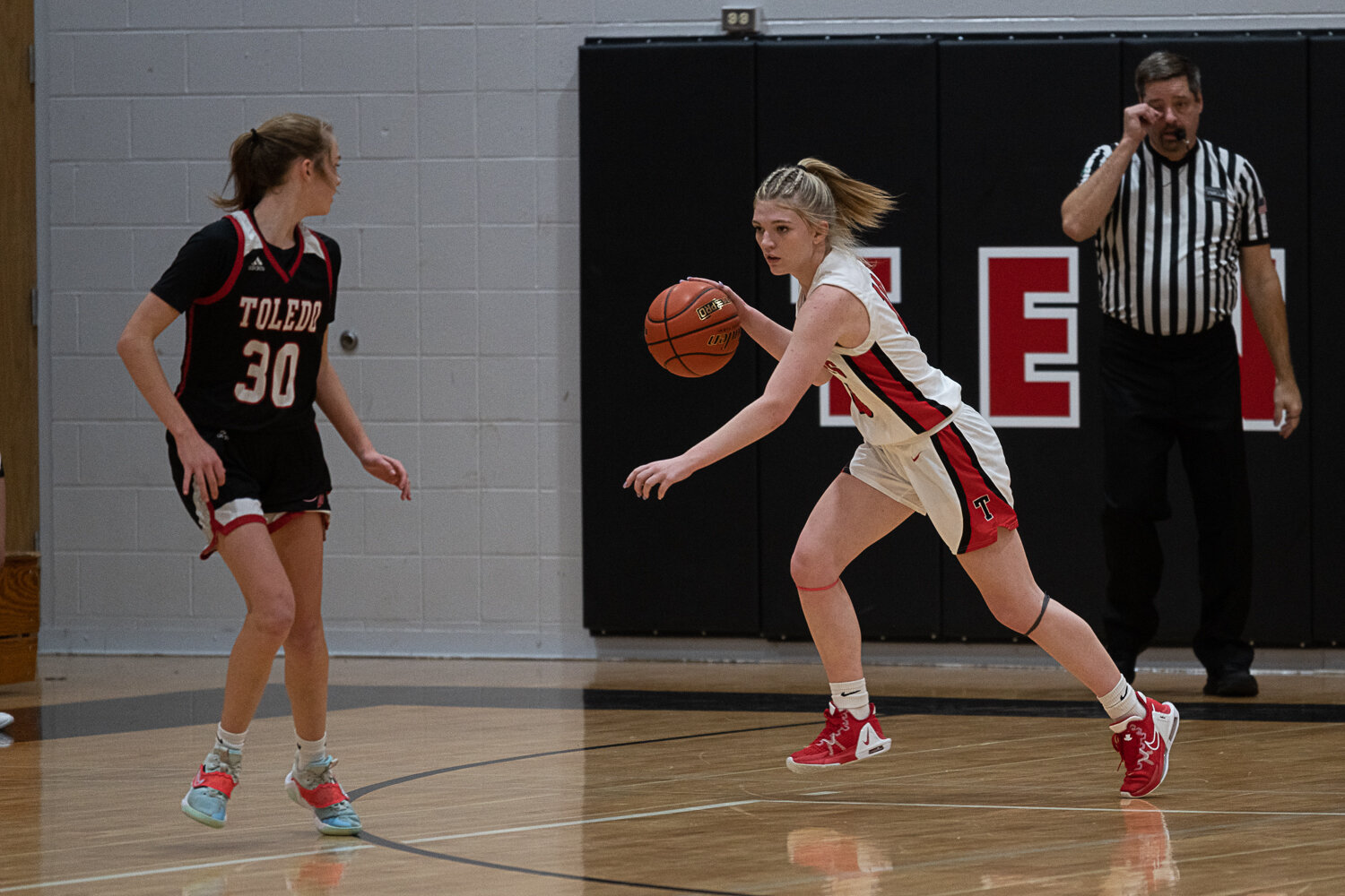 Brianna Asay starts a fast break after securing a rebound during Tenino's loss to Toledo on Nov. 29.