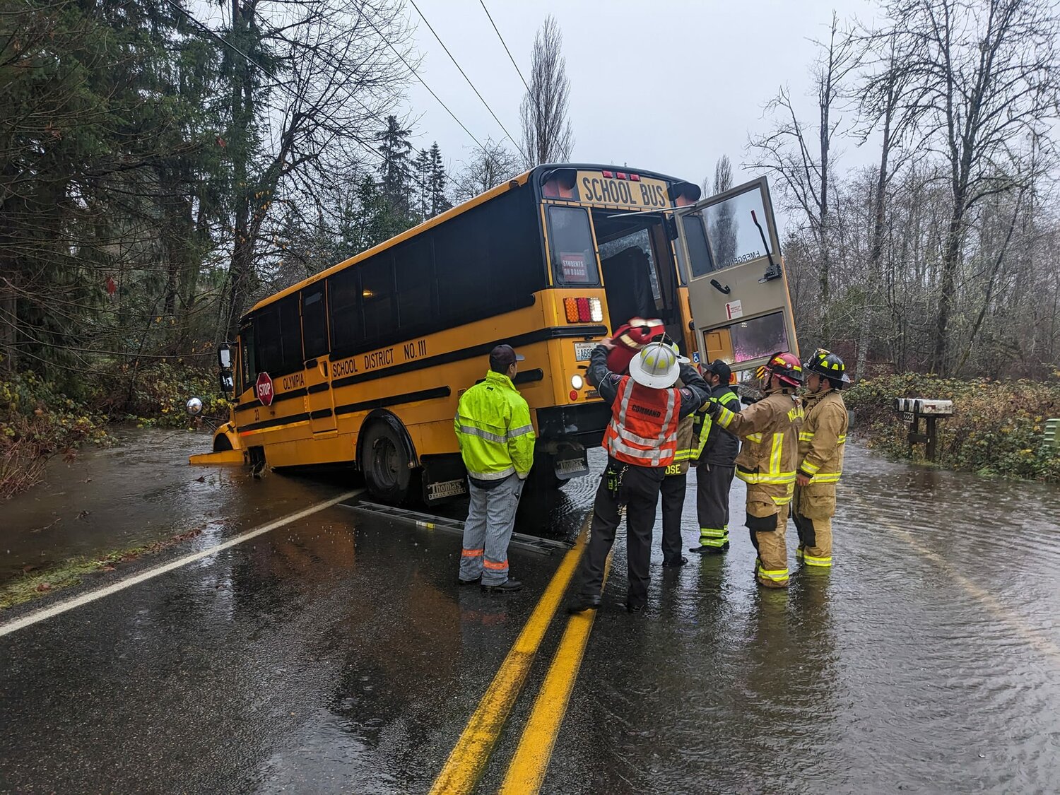 Firefighters helped rescue students from a bus that got stuck in flood waters northwest of Black Lake Tuesday morning.