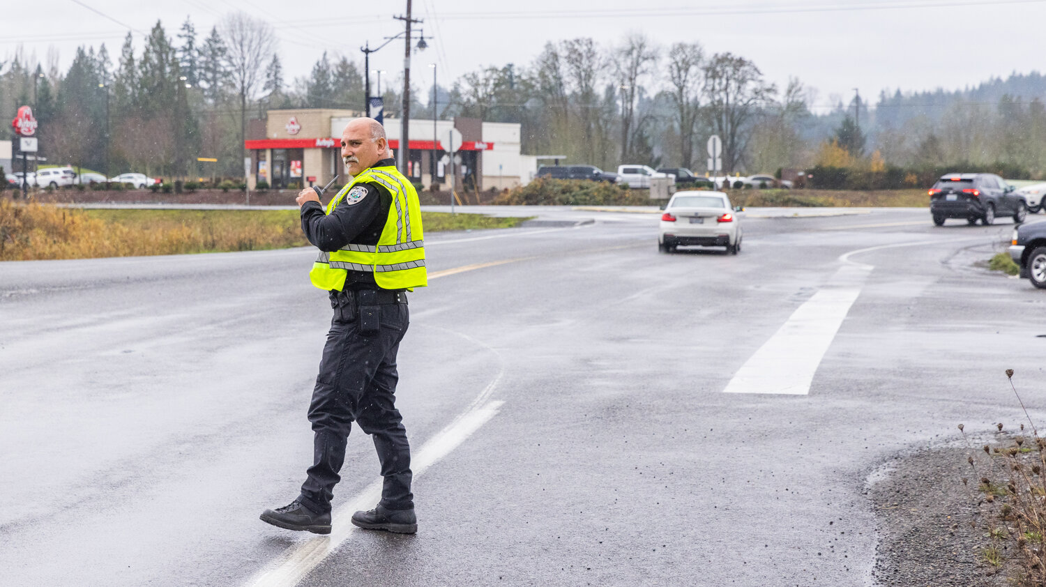 Napavine Chief of Police John Brockmueller directs traffic along West Forest Napavine Road on Wednesday, Dec. 6, after the truck struck the cement under the bridge for Interstate 5 and became lodged between supports.