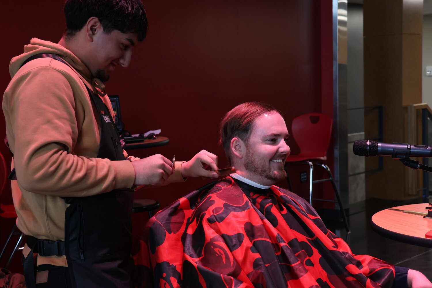 Justin Cabrera, a budding talent in the field of cosmetology, cuts the hair of Toledo Superintendent Brennan Bailey in this photo provided by the school district.