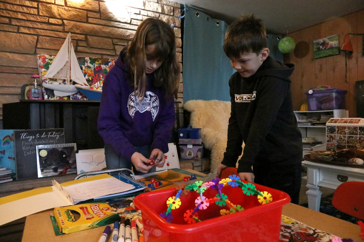 Lyla, 10, works on an algebra problem while Camden, 7, looks on at Sweet Tomatoes Learning Center in Chehalis on Wednesday, Dec. 6.