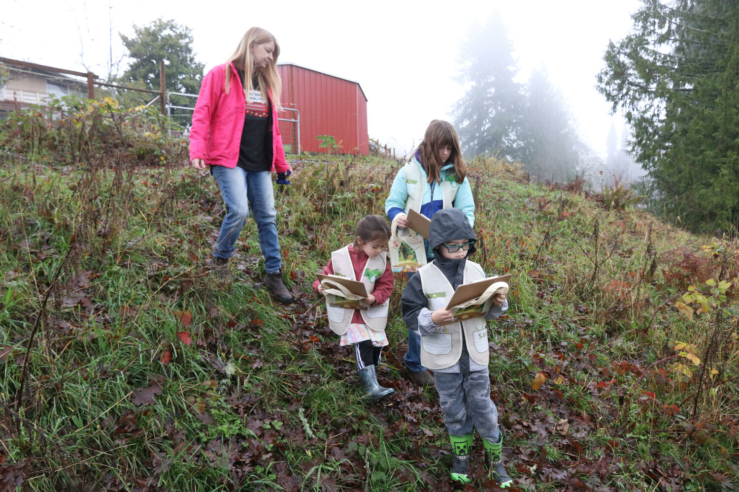 Sweet Tomatoes Learning Center Executive Director Kathleen Reed leads students on a nature hike on the center’s property in Chehalis on Wednesday, Dec. 6.