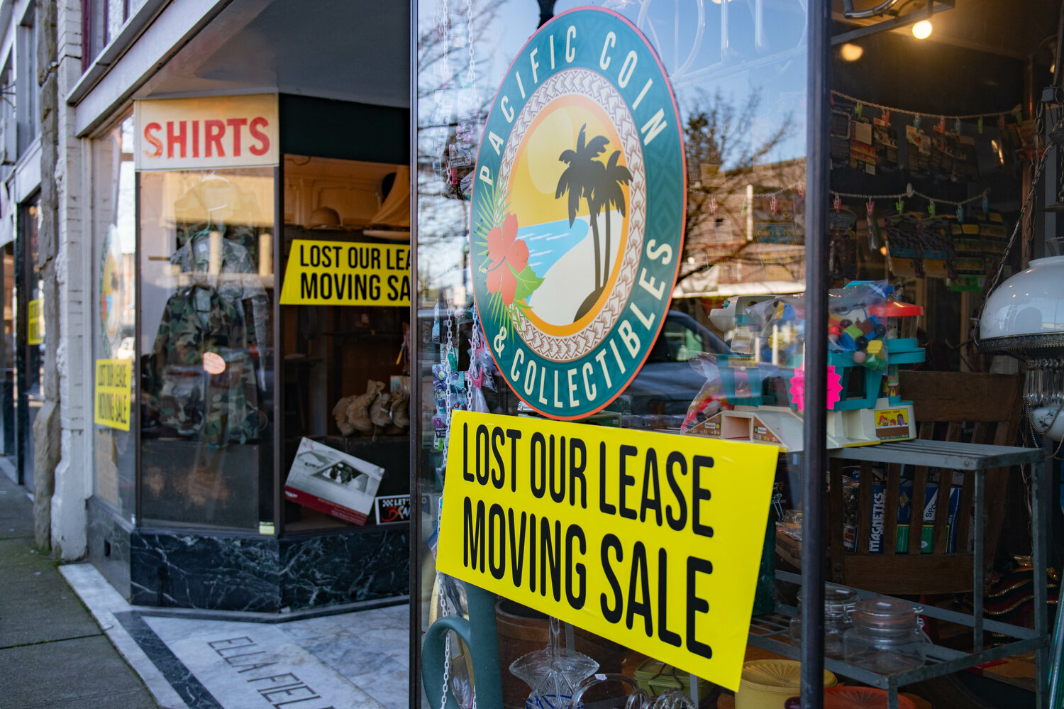 Moving sale signs are displayed outside of Pacific Coin & Collectibles and Alivia's Attic in downtown Centralia on Feb. 23.