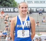 Adna’s Reagan Naillon smiles on the podium after placing sixth in the state for the girls 2B 400 meter dash at the 1A/2B/1B State track championship in Yakima on Saturday, May 27.