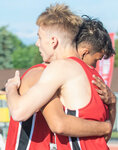 Toledo seniors Jordan McKenzie and Conner Olmstead embrace after winning the 2B State championship during the track and field meet in Yakima on Saturday.